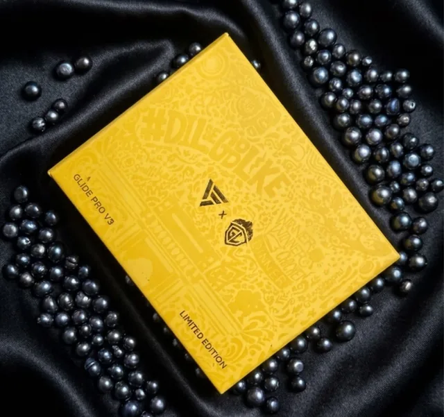 Yellow rigid box with a printed doodle pattern on black satin and pearls