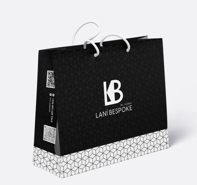 Black retail bag with geometric pattern base and cord handles