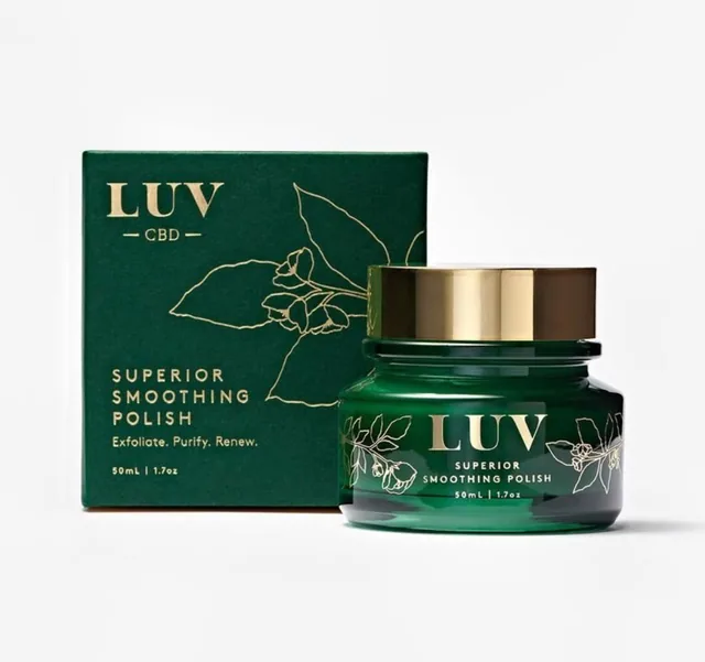 Deep green product carton with gold foil botanical line art next to a matching cosmetic jar