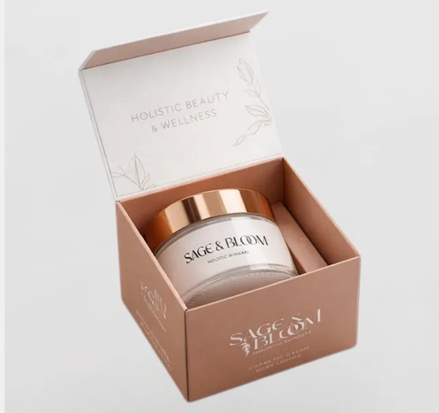 White and blush skincare box open around a cream jar